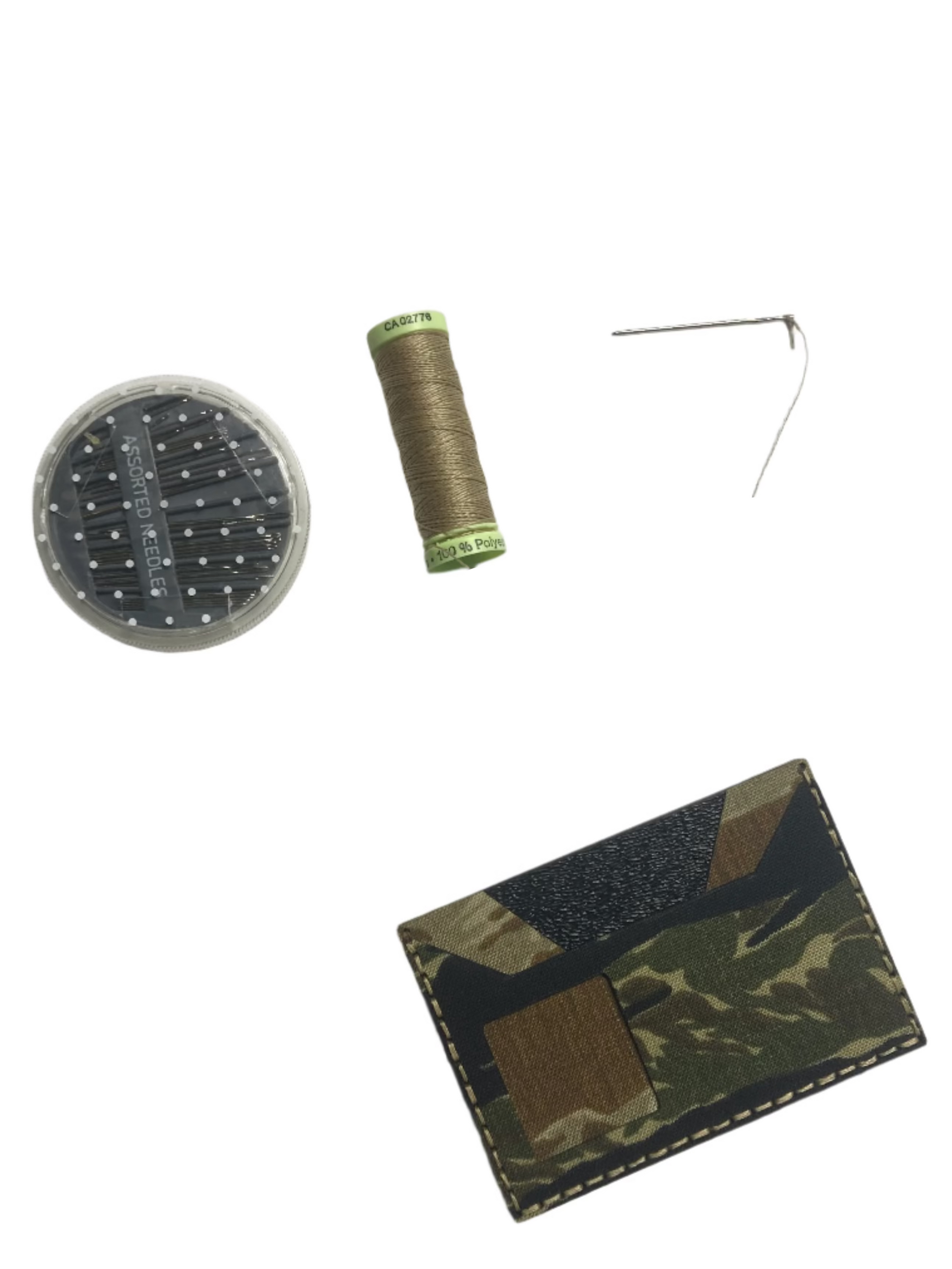 Camouflage cardholder with scissors, thread, and pins on a light gray background